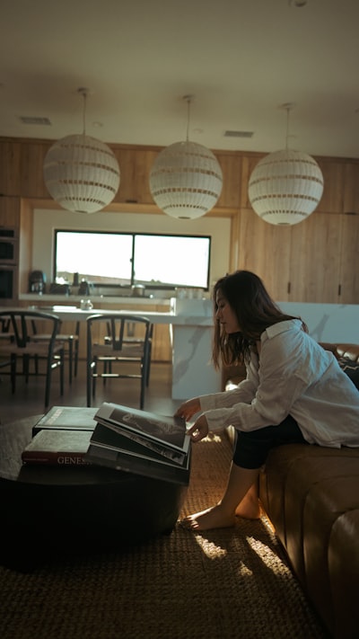 A woman reading a book on a couch