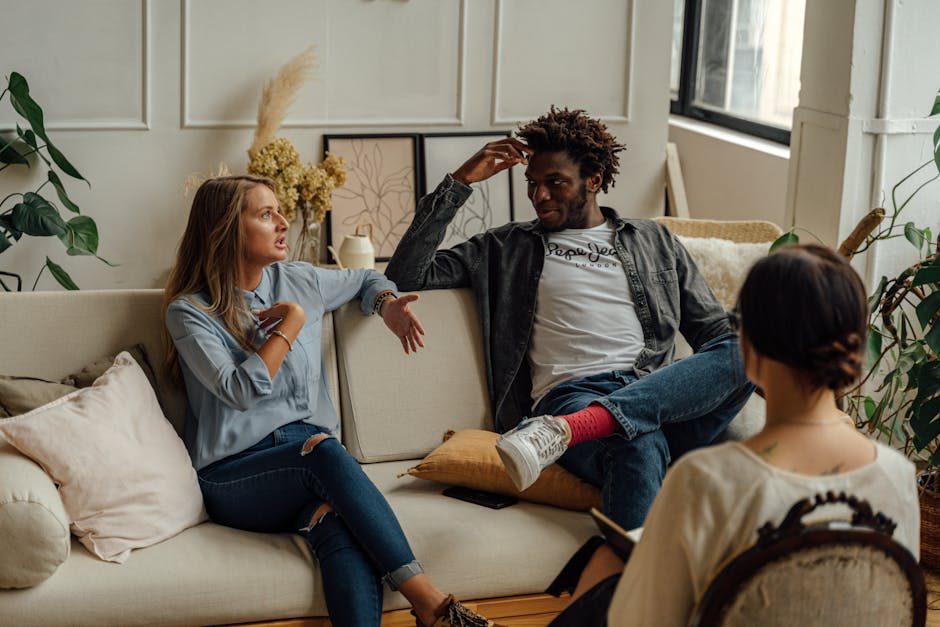 A couple is engaged in a lively conversation during a couples therapy session with a counselor.