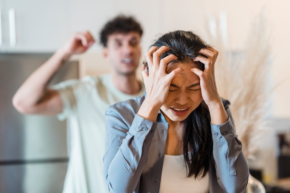 An upset couple arguing in a kitchen, highlighting stress and frustration in relationships.